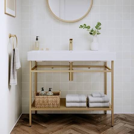 Brushed gold bathroom accessories with stone tile backdrop